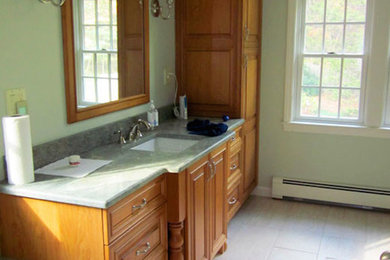 Example of a master beige tile bathroom design in Boston with a drop-in sink, beaded inset cabinets, medium tone wood cabinets and green walls
