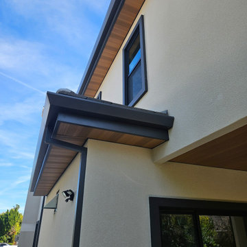 Wood Grained Metal Soffits with Angle Face Rain Gutters and Smooth Downspouts