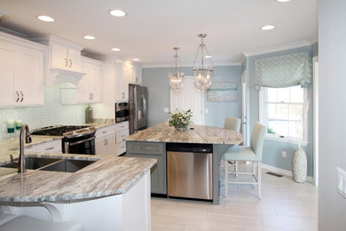 Eat-in kitchen - transitional l-shaped beige floor eat-in kitchen idea in Other with a double-bowl sink, white cabinets, stainless steel appliances, an island and gray countertops