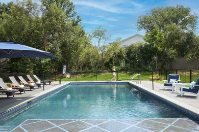 Inspiration for a mid-sized backyard stamped concrete and rectangular pool house remodel in Chicago