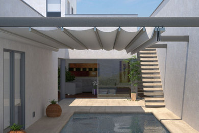 Imagen de jardín minimalista en verano con privacidad, exposición reducida al sol, adoquines de piedra natural y con metal