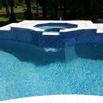 Tuscany Travertine with Blue Glass Tile Spa and spillway