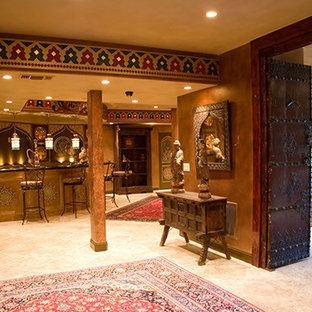 Photo of an expansive mediterranean enclosed home cinema in Sacramento with red walls, limestone flooring and a projector screen.