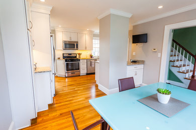 Kitchen - contemporary kitchen idea in Boston with shaker cabinets, white cabinets, granite countertops, white backsplash, subway tile backsplash, stainless steel appliances and a peninsula
