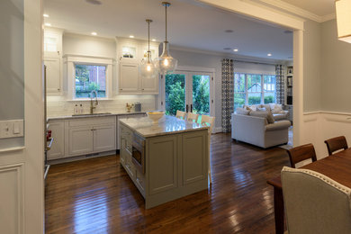 Eat-in kitchen - mid-sized cottage l-shaped medium tone wood floor eat-in kitchen idea in DC Metro with an undermount sink, beaded inset cabinets, white cabinets, quartzite countertops, white backsplash, porcelain backsplash, stainless steel appliances and an island