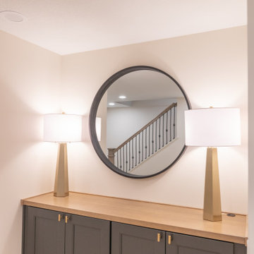 Warm & Inviting Basement Retreat with Custom Bar + Entertainment Center