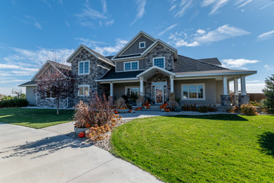 Large gray two-story stucco and board and batten exterior home photo in Denver with a shingle roof and a gray roof