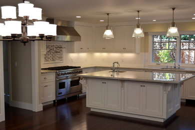 Eat-in kitchen - craftsman l-shaped eat-in kitchen idea in Other with a single-bowl sink, recessed-panel cabinets, white cabinets, granite countertops, white backsplash, subway tile backsplash and stainless steel appliances