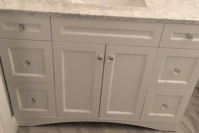 Inspiration for a mid-sized transitional master gray tile, white tile and marble tile marble floor bathroom remodel in Baltimore with furniture-like cabinets, white cabinets, white walls, an undermount sink, marble countertops and a one-piece toilet