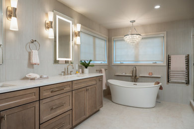 Bathroom - large modern master gray tile and porcelain tile porcelain tile, gray floor and double-sink bathroom idea in Philadelphia with recessed-panel cabinets, medium tone wood cabinets, a bidet, gray walls, an undermount sink, quartz countertops, a hinged shower door, white countertops and a freestanding vanity