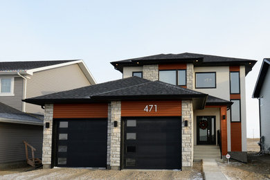 Mid-sized trendy multicolored two-story mixed siding exterior home photo in Edmonton with a hip roof