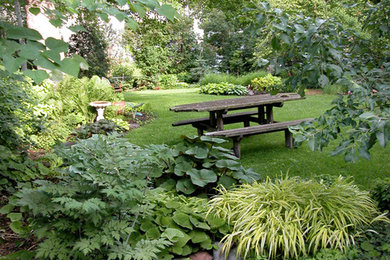Photo of a huge eclectic partial sun brick landscaping in Minneapolis for summer.