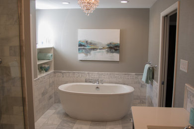 Freestanding bathtub - large transitional master white tile and marble tile marble floor and gray floor freestanding bathtub idea in St Louis with shaker cabinets, gray cabinets, gray walls and quartz countertops