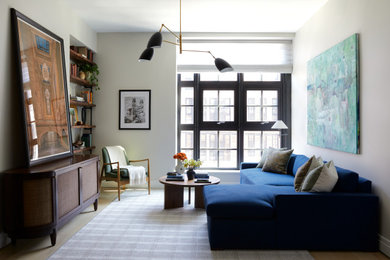 Example of a transitional light wood floor and beige floor living room design in New York with beige walls