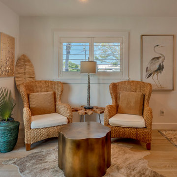Cozy Window Lounge with Wicker Chairs and Rustic Accents in a Modern Coastal Liv