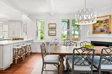 Inspiration for a transitional medium tone wood floor and brown floor kitchen/dining room combo remodel in DC Metro with white walls, a corner fireplace and a stone fireplace