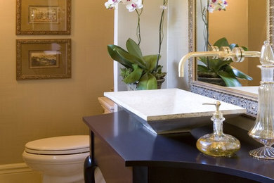 Inspiration for an eclectic beige tile powder room remodel in Detroit with a vessel sink, wood countertops, a two-piece toilet and blue countertops