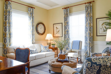 Example of a mid-sized transitional freestanding desk medium tone wood floor and brown floor home office design in Oklahoma City with yellow walls
