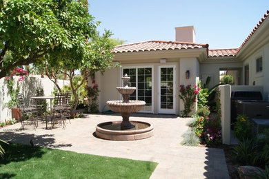 Mid-sized beach style white one-story stucco house exterior photo in Los Angeles with a hip roof and a tile roof