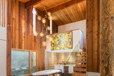 Mid-century modern dining room photo in San Diego