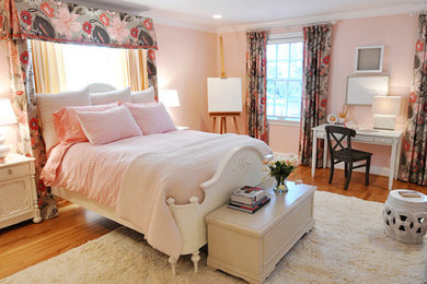 Example of a large eclectic medium tone wood floor bedroom design in DC Metro with pink walls and no fireplace