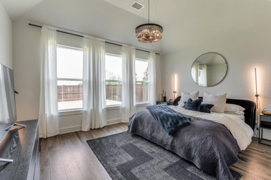 Inspiration for a large contemporary master laminate floor and brown floor bedroom remodel in Dallas with white walls and no fireplace
