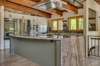 Mid-sized mountain style l-shaped light wood floor, brown floor and exposed beam open concept kitchen photo in Sacramento with an undermount sink, shaker cabinets, white cabinets, quartzite countertops, multicolored backsplash, stainless steel appliances, an island and multicolored countertops