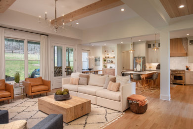 Example of a large transitional open concept light wood floor, brown floor and exposed beam family room design in Atlanta with a bar, white walls, a standard fireplace, a stone fireplace and a wall-mounted tv