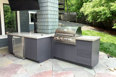 Example of a small beach style backyard patio kitchen design in Minneapolis with decking