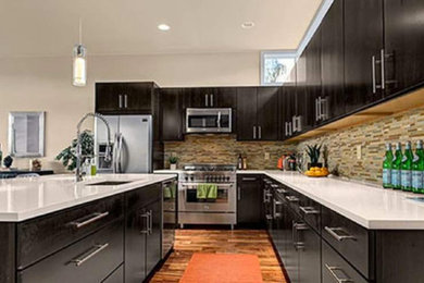Kitchen - large transitional l-shaped medium tone wood floor and brown floor kitchen idea in Other with an undermount sink, flat-panel cabinets, dark wood cabinets, quartzite countertops, brown backsplash, glass tile backsplash, stainless steel appliances and an island