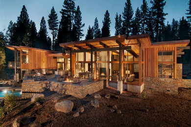 Example of a large mountain style brown two-story wood exterior home design in San Francisco with a shed roof