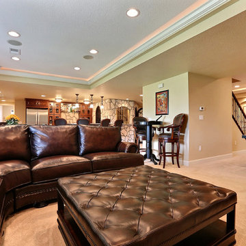 Open Basement Concept in Centennial, CO with tray ceilings and stacked stone