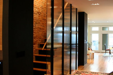 Hallway - mid-sized transitional medium tone wood floor and beige floor hallway idea in New York with brown walls