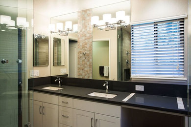 Example of a mid-sized trendy beige tile and glass tile ceramic tile bathroom design in San Francisco with shaker cabinets, white cabinets, a one-piece toilet, beige walls, an undermount sink and quartz countertops