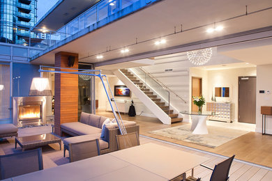 Patio - huge modern patio idea in Toronto with a fire pit and decking