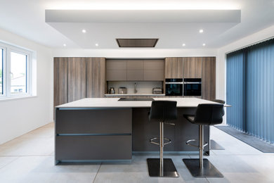 This is an example of a modern kitchen in Devon with an island.