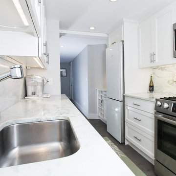Streamlined Galley Kitchen with Marble Counters and Stainless Appliances – North