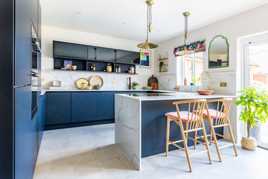 Medium sized contemporary kitchen in Kent with a built-in sink, flat-panel cabinets, white cabinets, marble worktops, white splashback, marble splashback, black appliances, ceramic flooring, grey floors and white worktops.