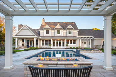 Inspiration for a large timeless backyard stone and rectangular lap hot tub remodel in Kansas City