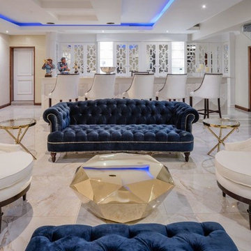 Entertainment area,mirror cocktail bar,navy velvet sofa,off-white barstools and