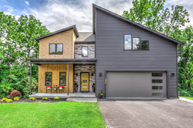 Trendy two-story vinyl house exterior photo with a shingle roof