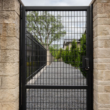 Custom Metal Fence & Electric Driveway Gate with Stone Accents