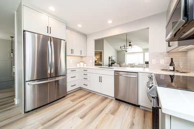 Trendy kitchen photo in Edmonton with recessed-panel cabinets