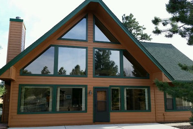 Inspiration for a large rustic brown two-story wood exterior home remodel in Phoenix