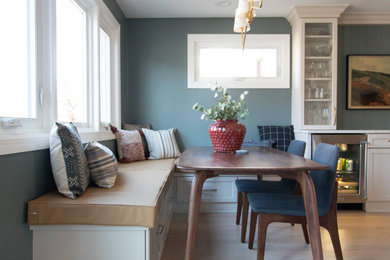 Diseño de comedor moderno con paredes azules, suelo de madera clara y suelo marrón