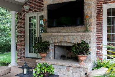 Patio - traditional backyard stone patio idea in St Louis with a fire pit and a gazebo