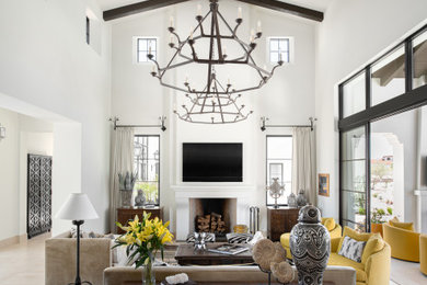 Living room - mediterranean dark wood floor, brown floor, exposed beam and vaulted ceiling living room idea in Phoenix with white walls, a standard fireplace and a wall-mounted tv