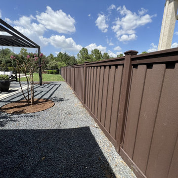 Dark Brown Composite Trex Fence and Black Iron Fence