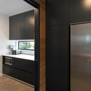 Design ideas for a contemporary galley kitchen pantry in Brisbane with black cabinets, window splashback, ceramic floors, grey floor and white benchtop.