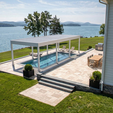 White Motorized Louvered Pergola Over a Lakefront Swim Spa on a Multilevel Trave